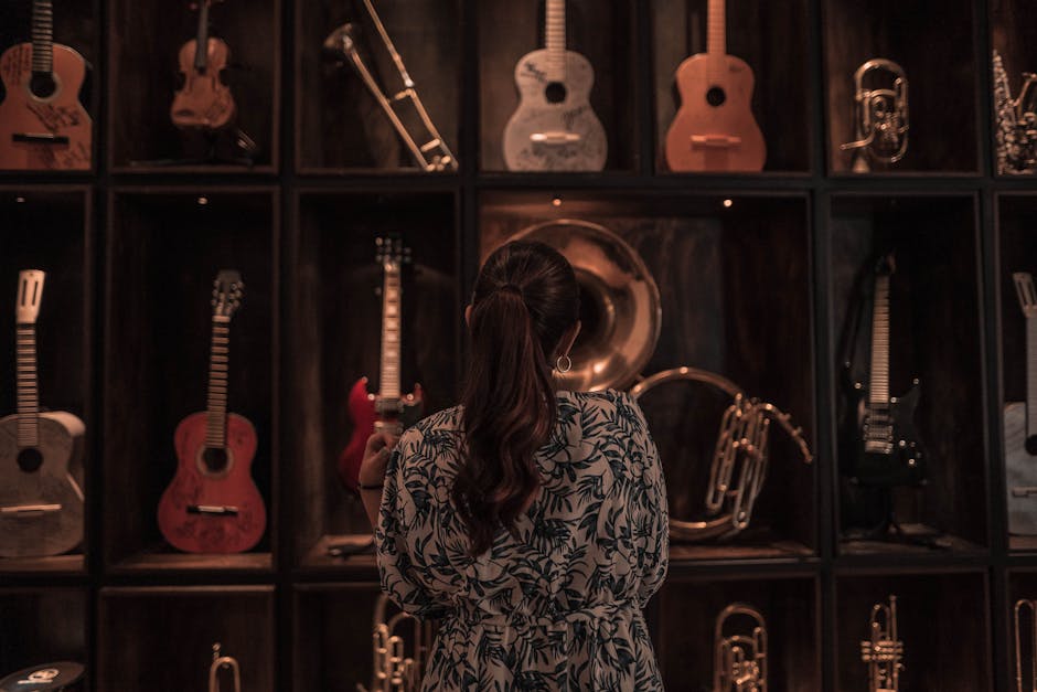 Visitante observando instrumentos musicales en exposición